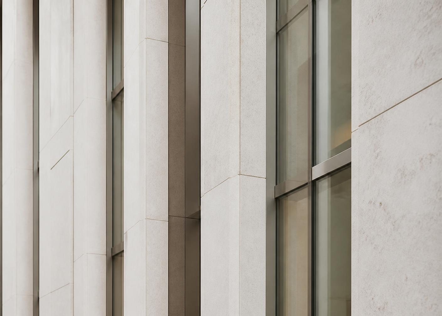 Detail of a modern stone and glass building facade