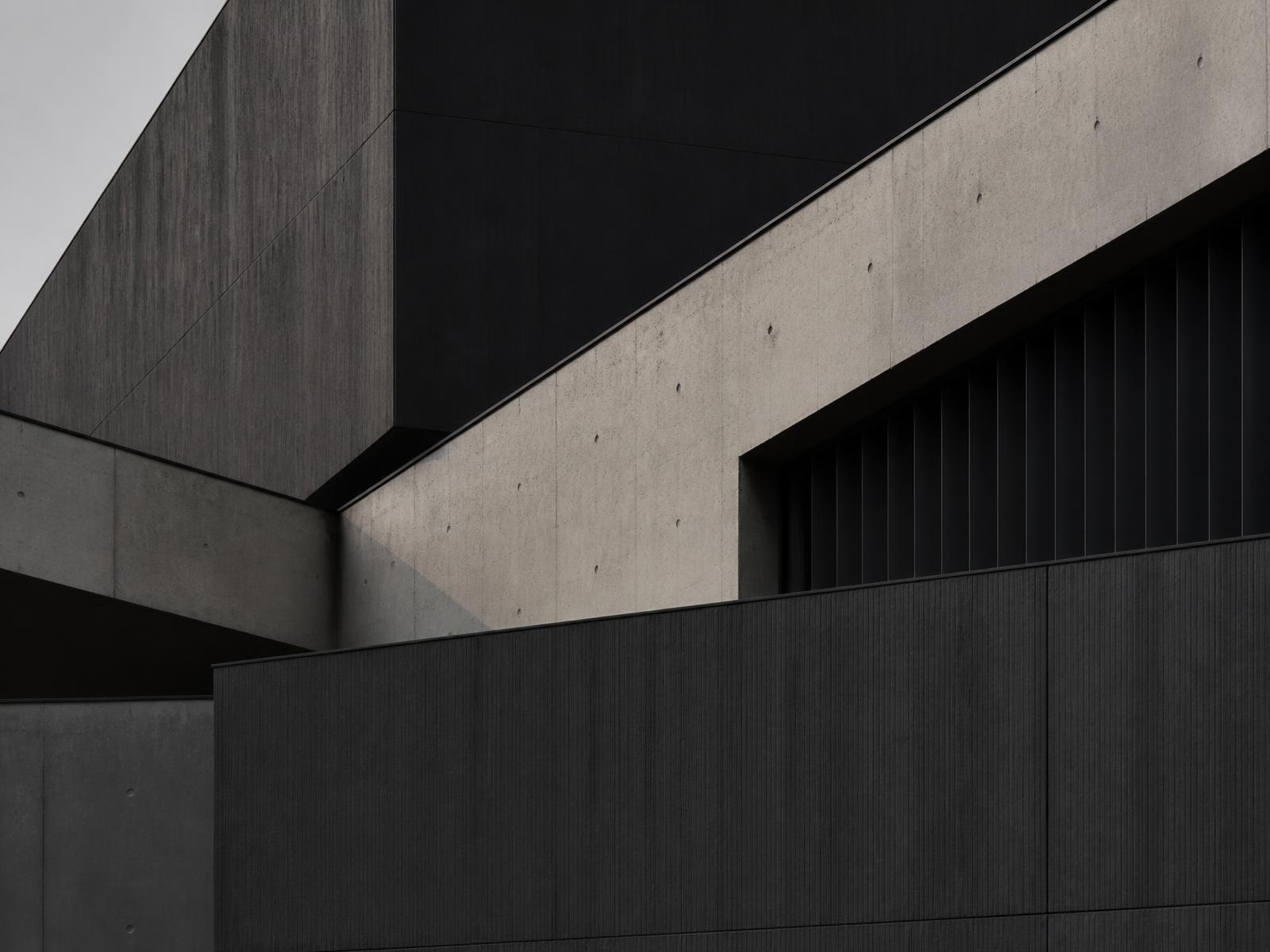 Abstract modern architectural facade in anthracite and stone tones